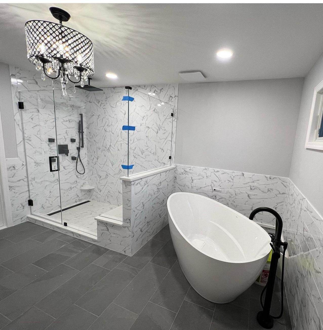 Bathroom with a freestanding tub and gray floor tile