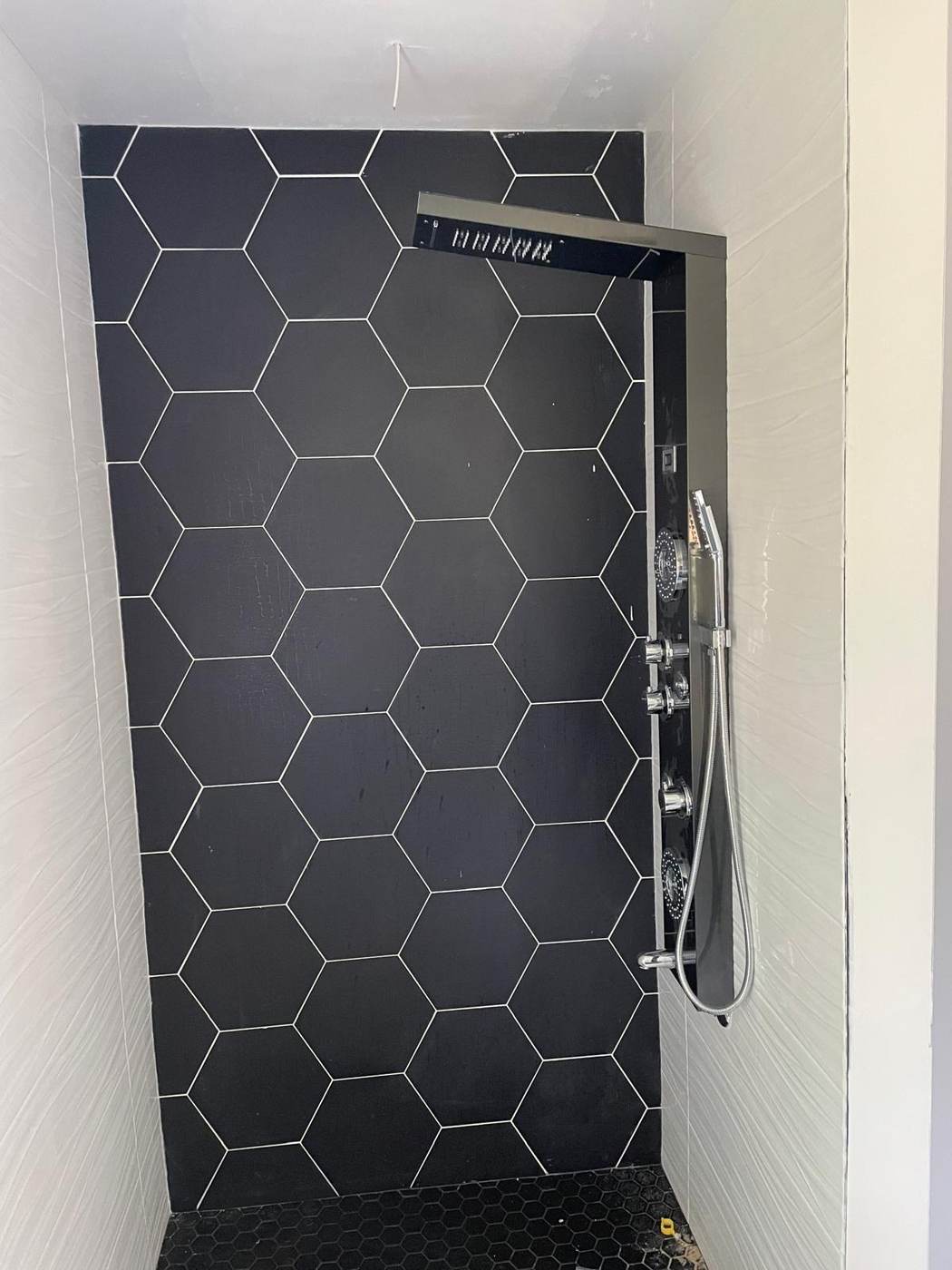 Black hexagon tile shower wall